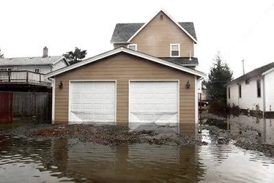 Floodwater surrounding a house and garage