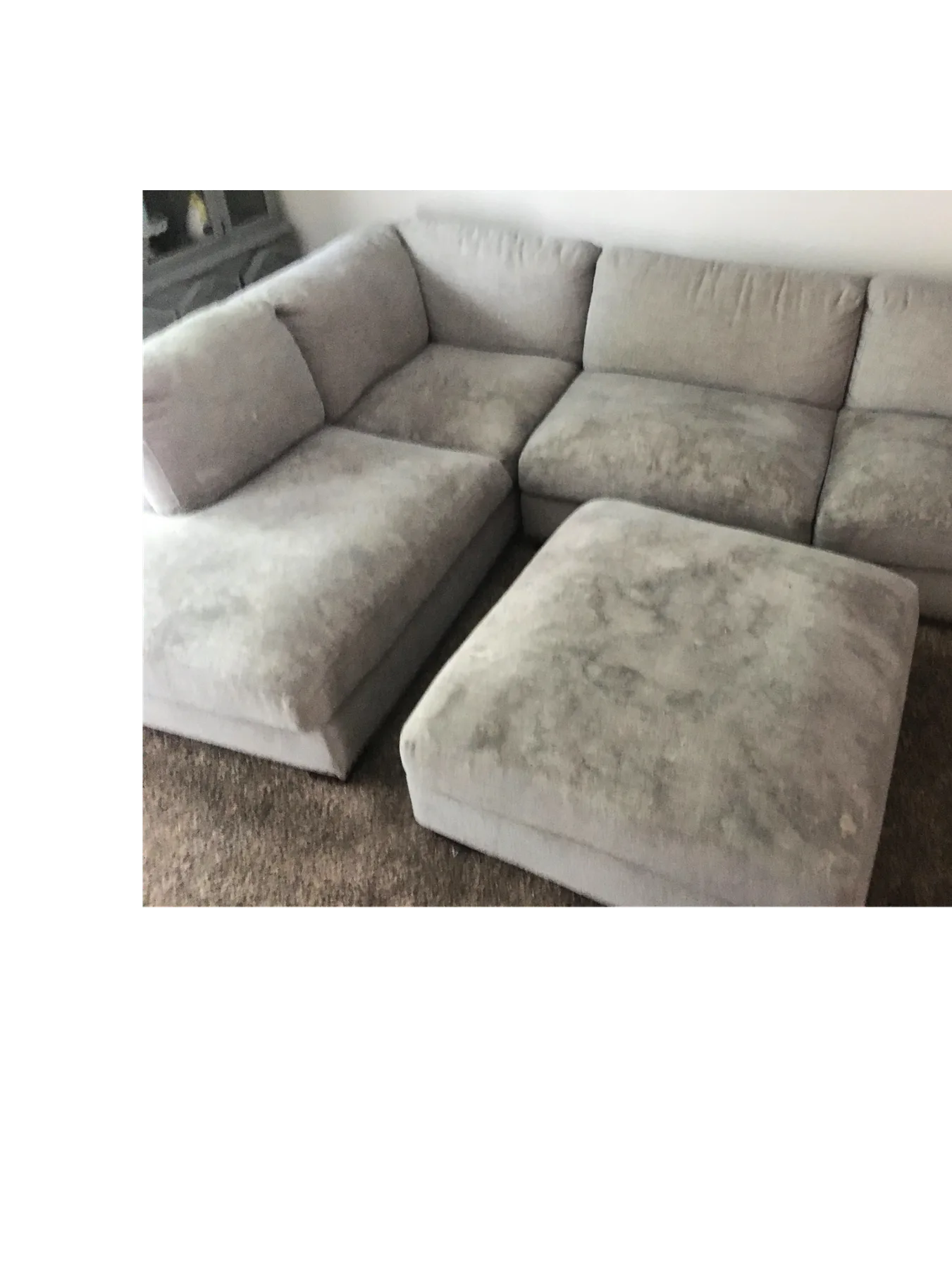 Sectional sofa with visible soil before upholstery cleaning
