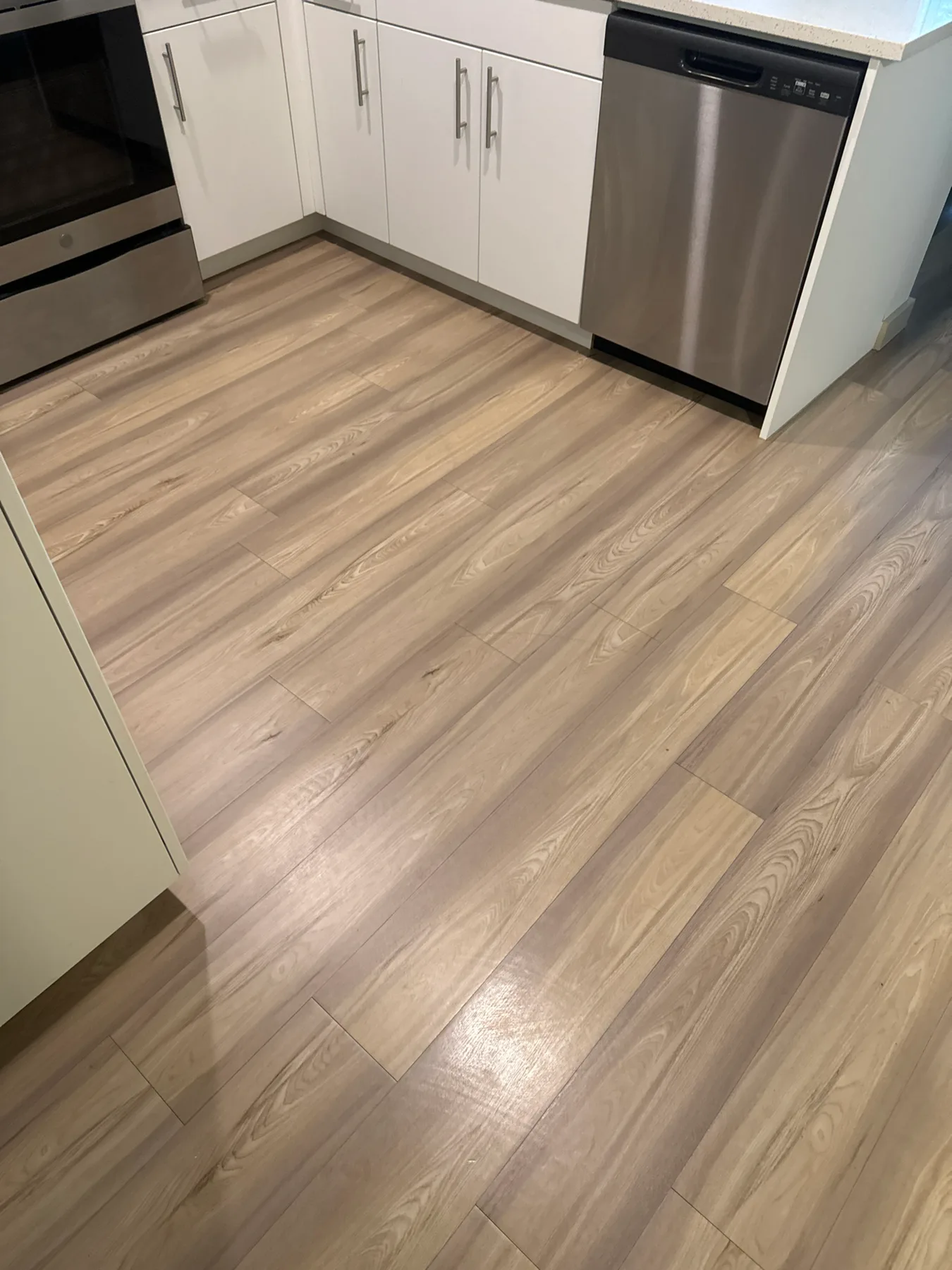 Wood-look vinyl kitchen floor before cleaning